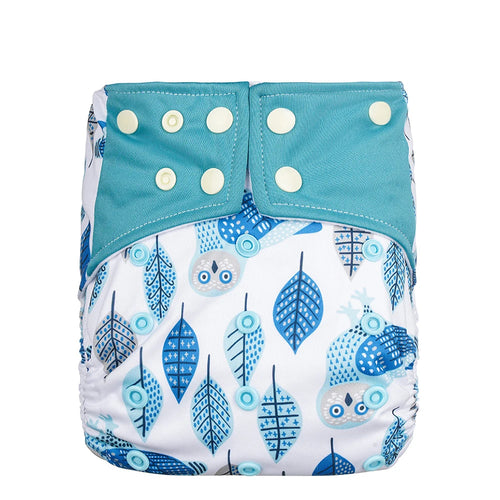 A reusable cloth diaper with a white base printed with blue owl and leaf patterns, featuring a solid teal blue waistband with white snap closures.